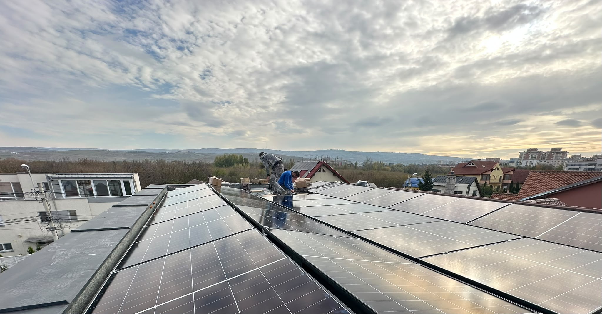 Installer fitting solar panels on a roof
